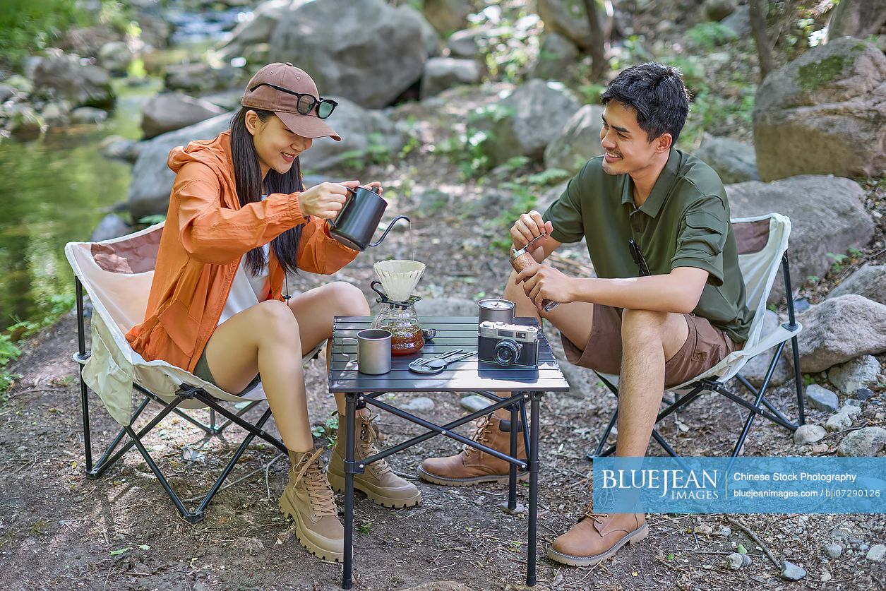 Happy couple sipping tea and enjoying the tranquil surroundings