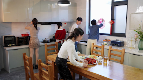 Young friends gathered around the table for a meal
