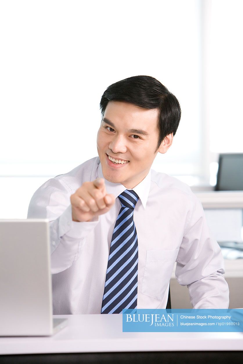 Chinese office worker at his desk