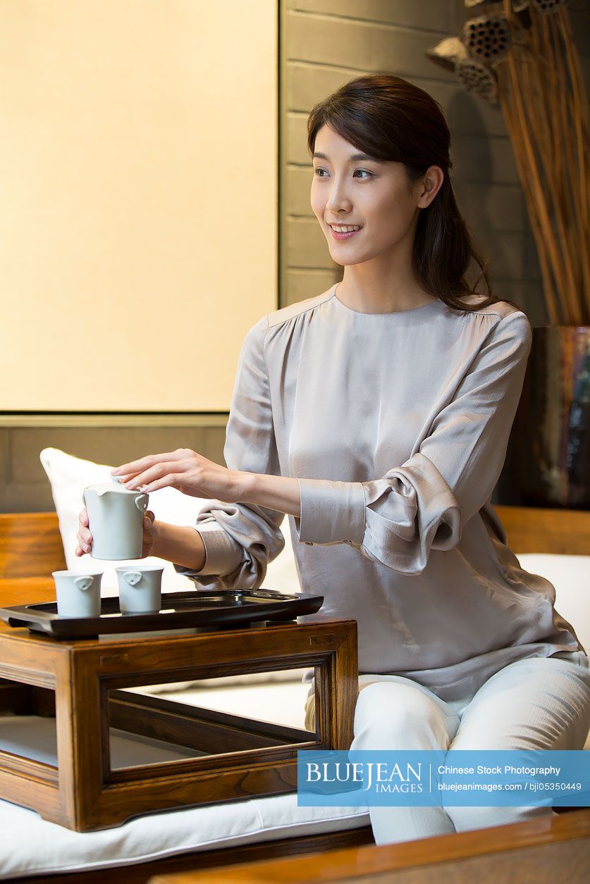 Young Chinese woman performing tea ceremony