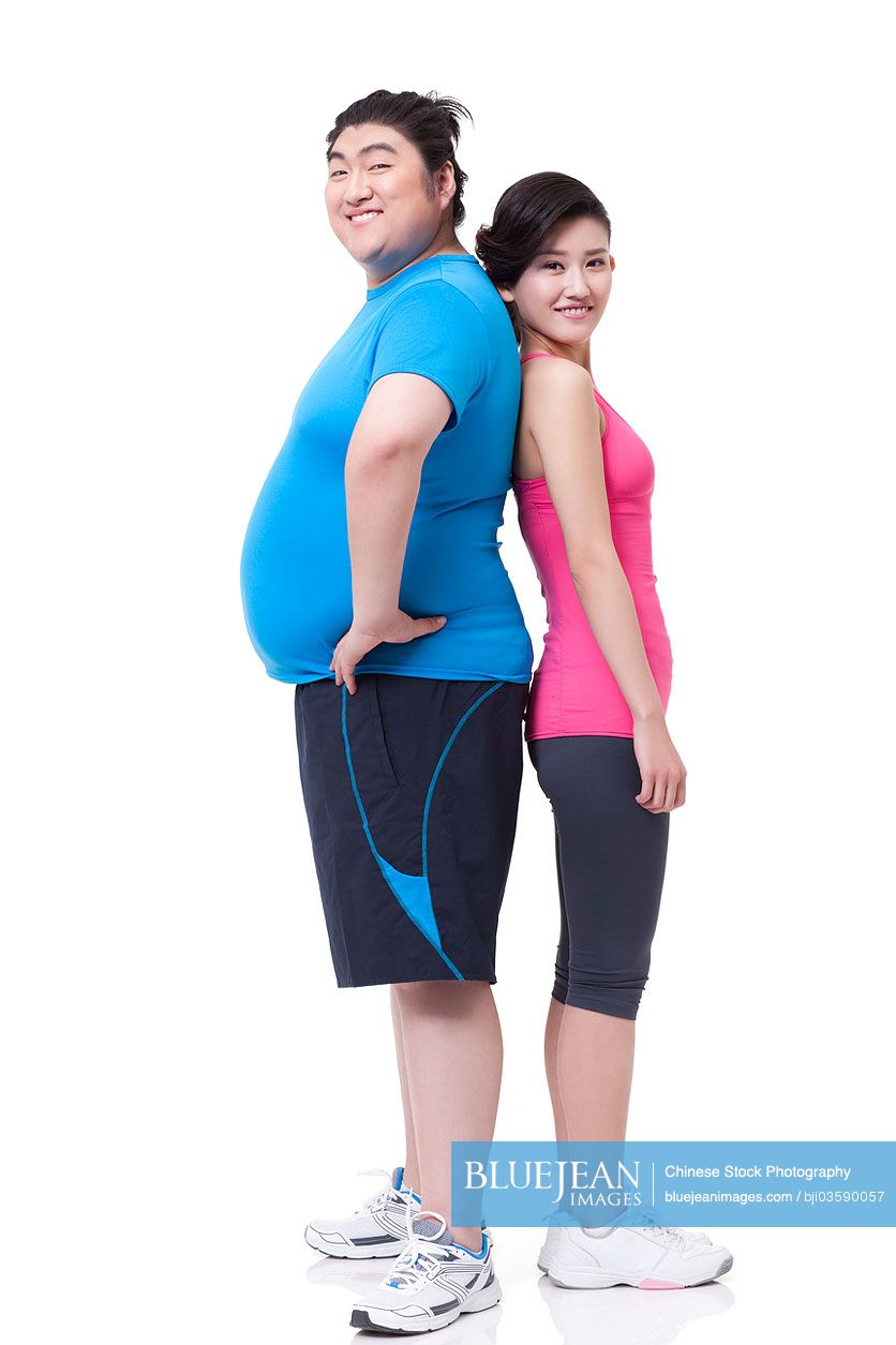 Happy Chubby Chinese man and young woman standing back to back