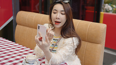 Beautiful young Chinese woman applying lipstick,4K