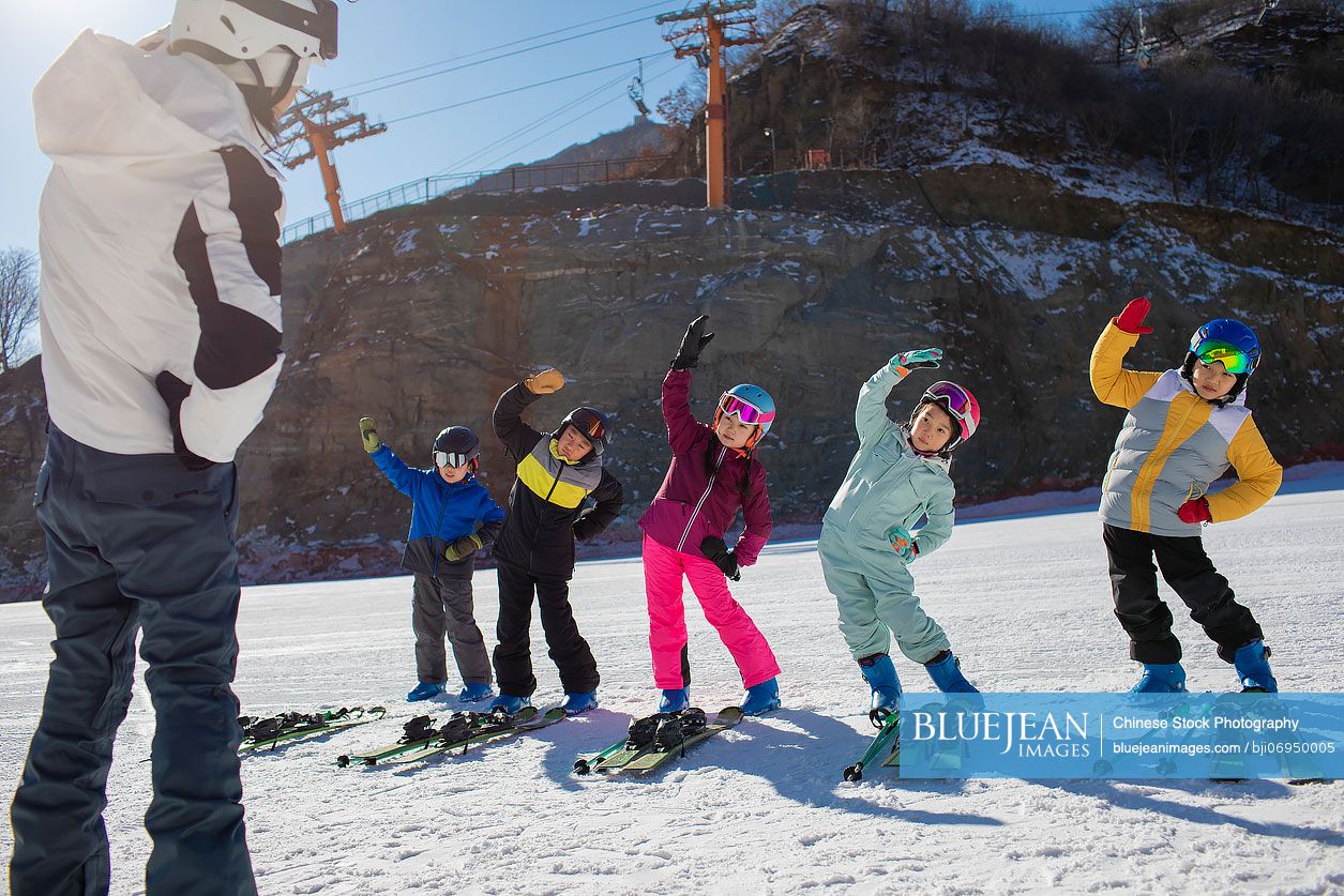 Chinese children learning how to ski with their coach