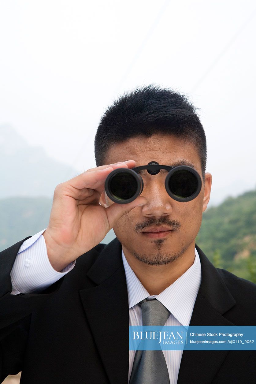A Chinese businessman looks into the distance
