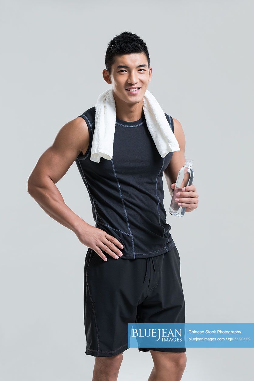 Male Chinese athlete with a bottle of water