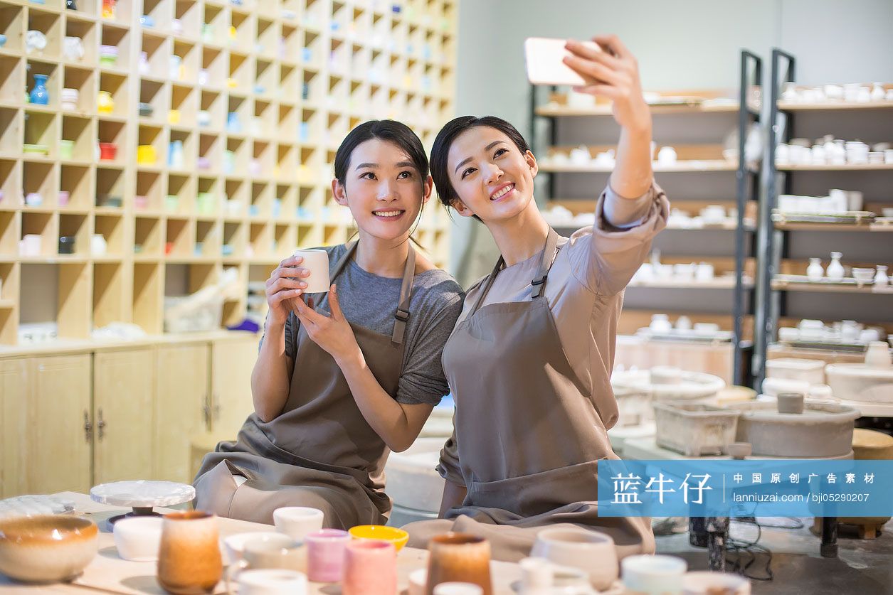 年轻陶艺师在工作室用手机自拍