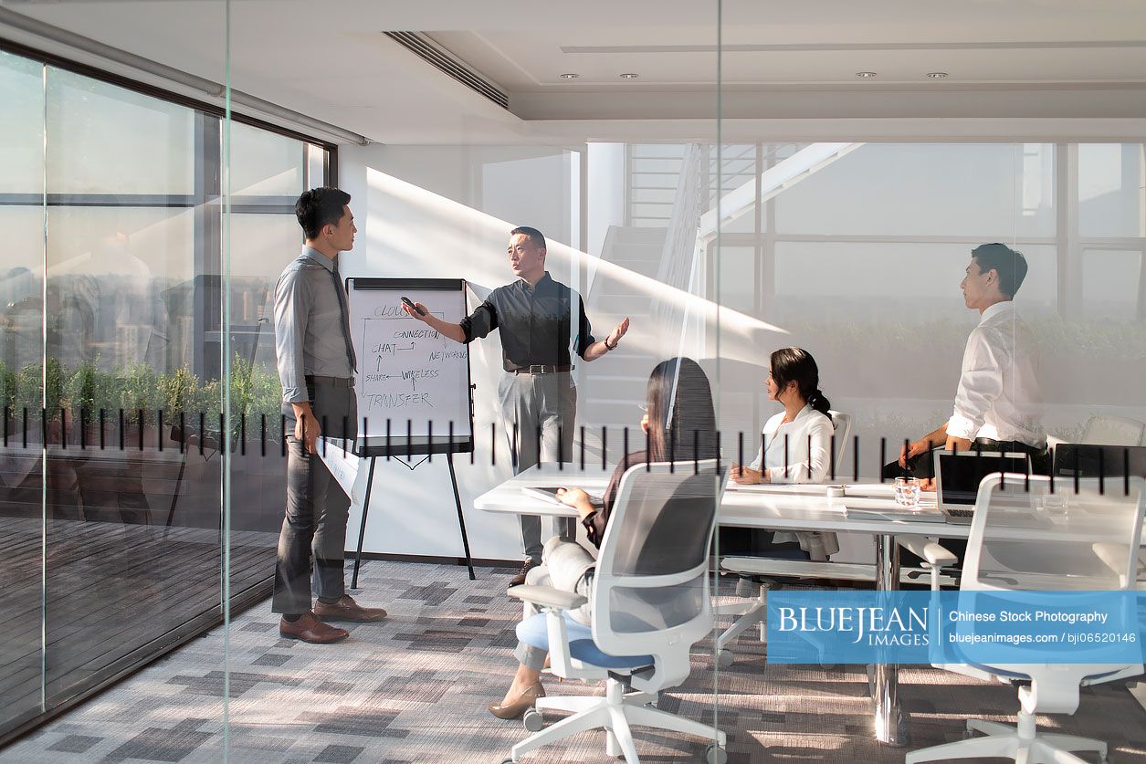 Chinese business people having meeting in board room