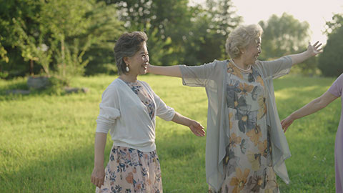 Happy senior Chinese friends relaxing in park,4K