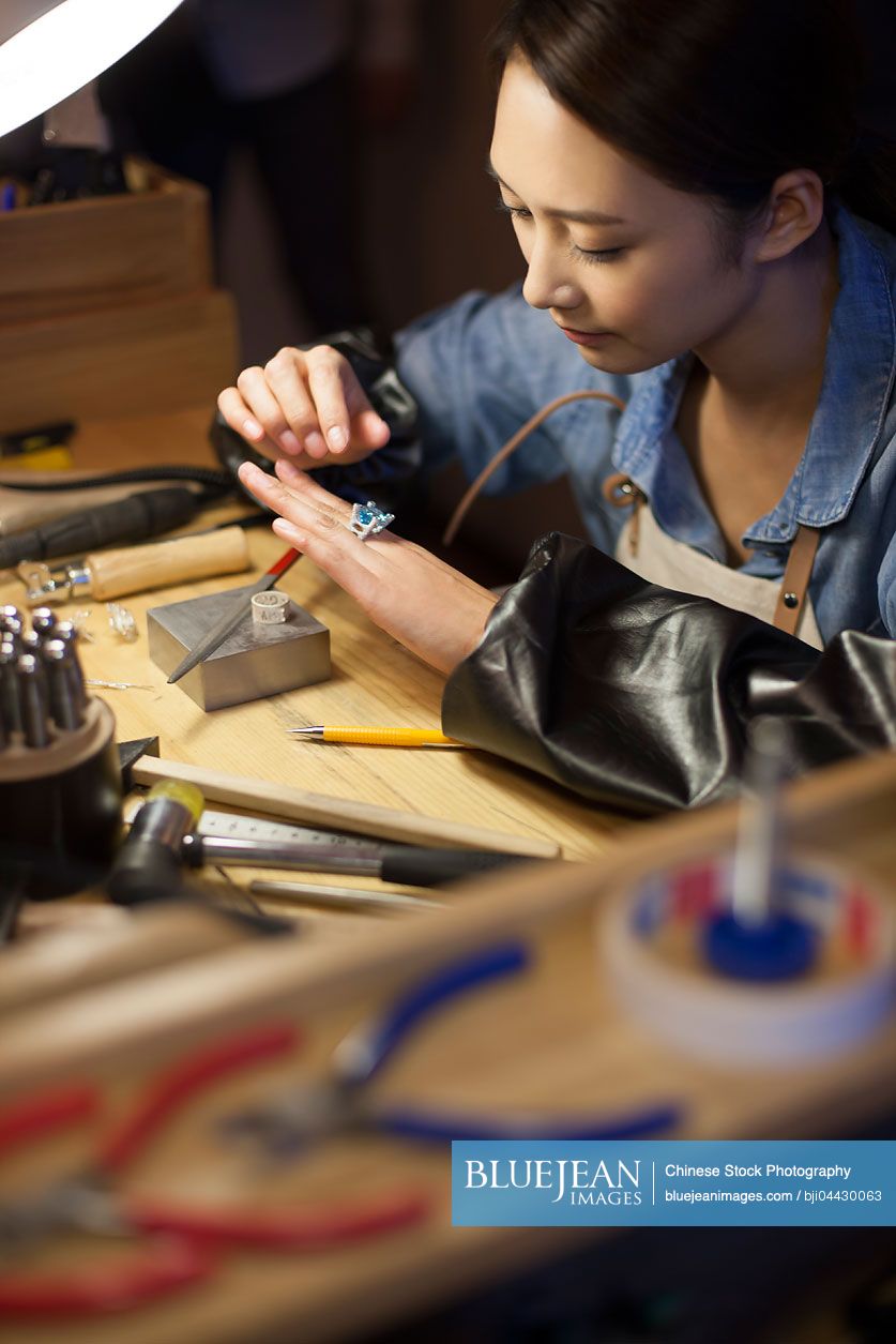 Chinese female jeweler making a sapphire ring