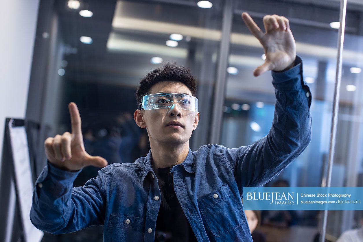 Young Chinese man wearing futuristic glasses