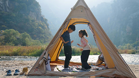 Cute Chinese Children relaxing in tent