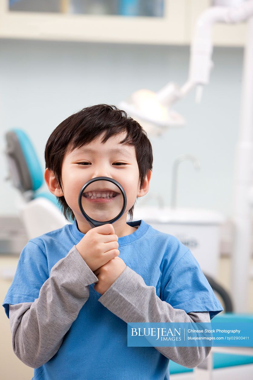 Cute little Chinese boy in dental clinic