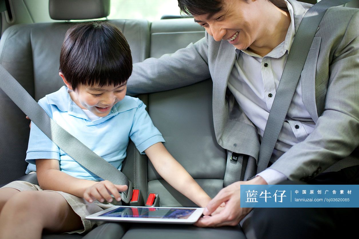 爸爸和儿子在车上玩平板电脑