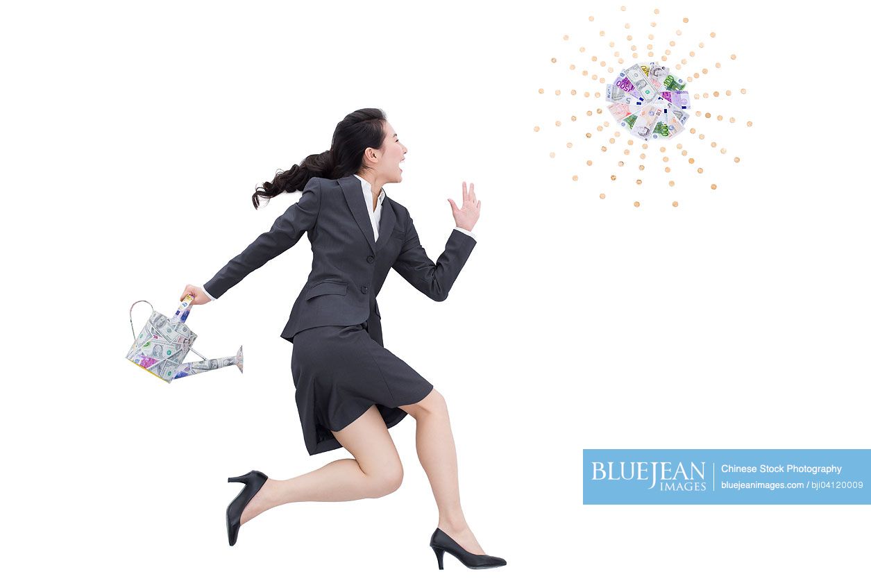 Chinese businesswoman with watering can high res stock photo for download