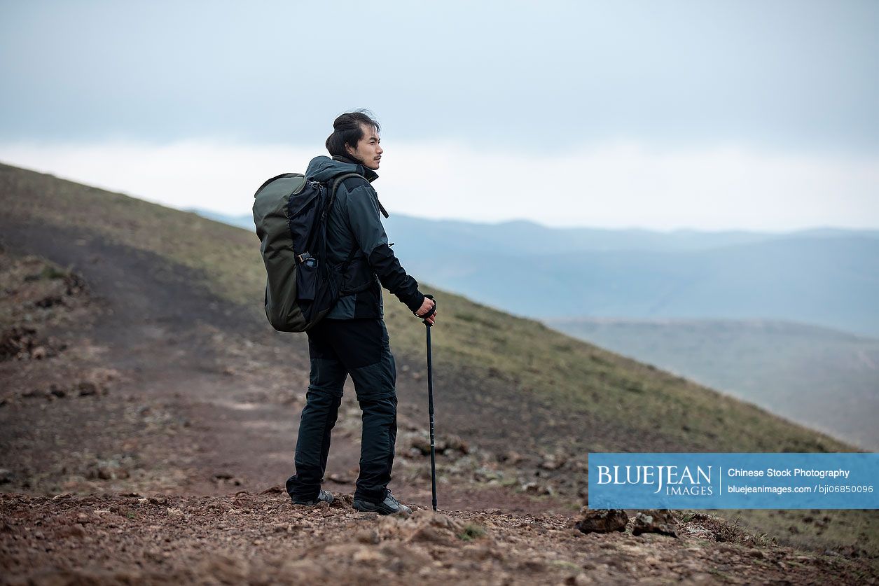 Chinese mid adult man hiking outdoors