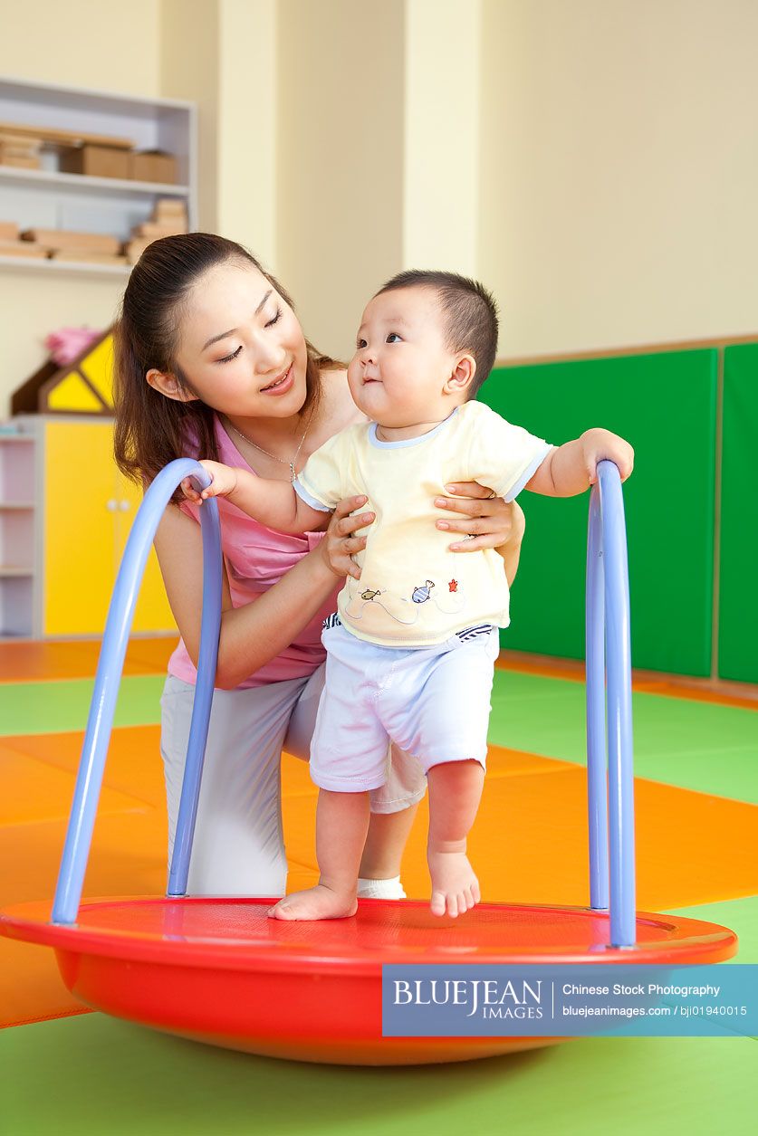 Chinese mother playing with son