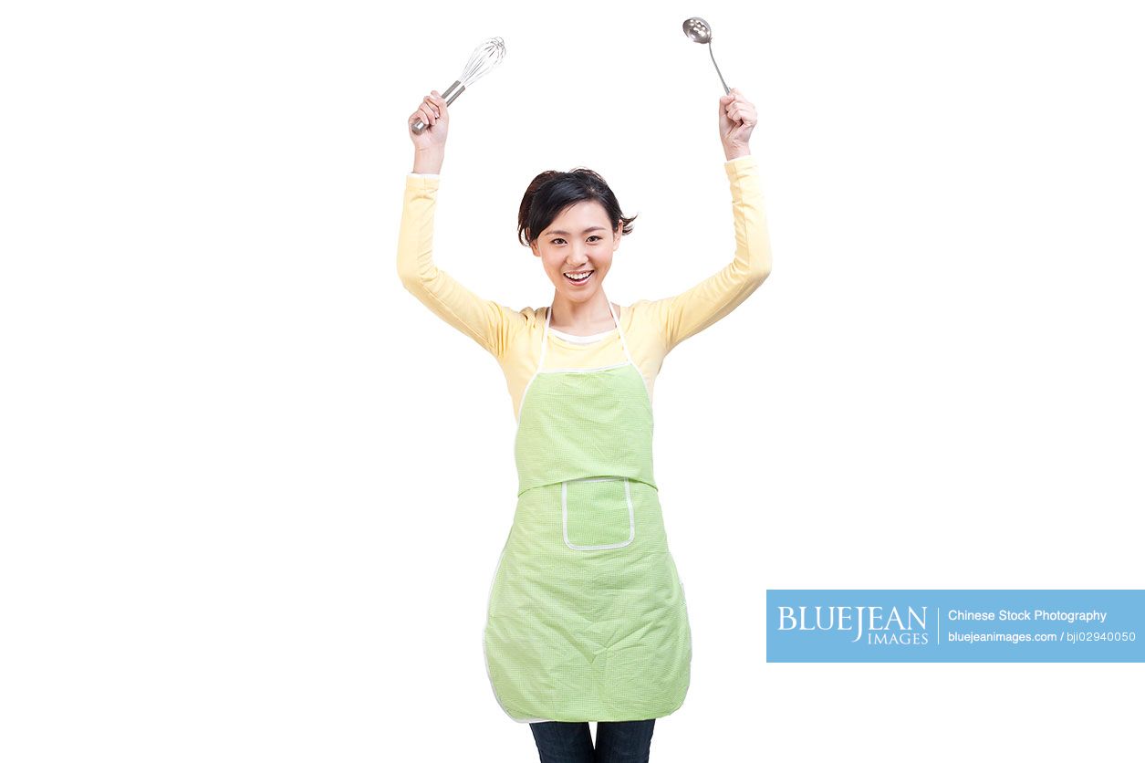 Happy Chinese housewife and cooking utensils