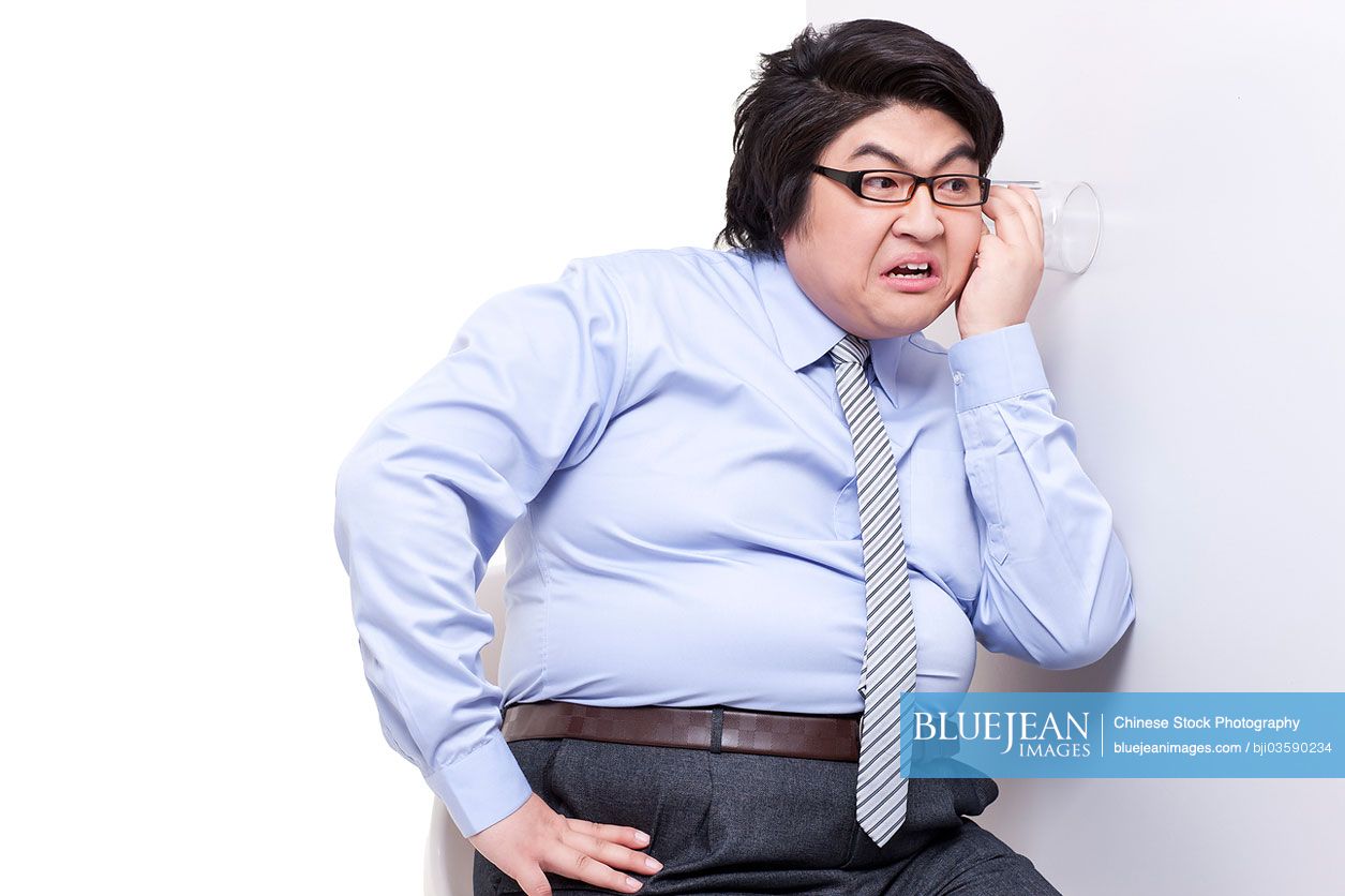 Overweight businessman doing eavesdropping