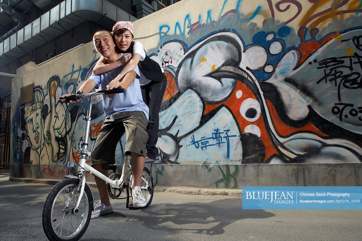 Chinese teenage boy and girl on a bike