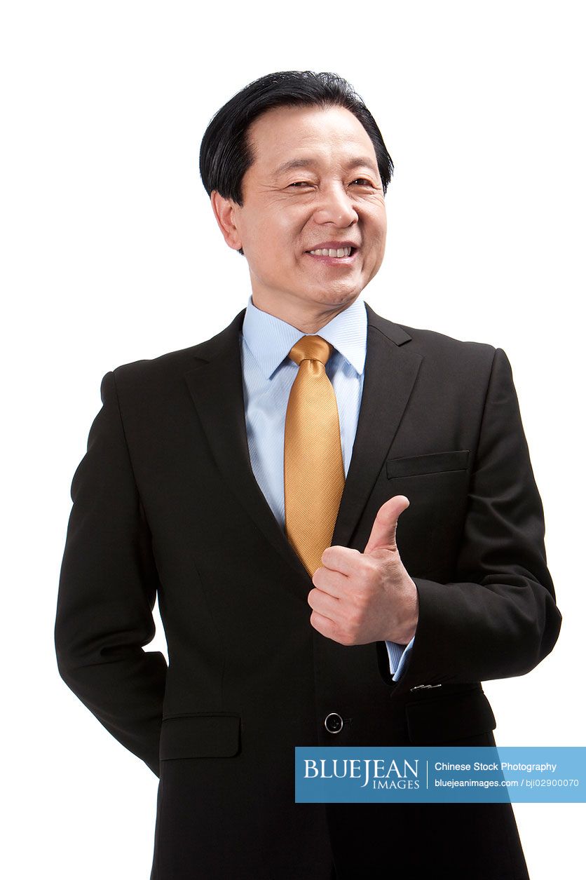 Senior Chinese businessman doing thumbs-up