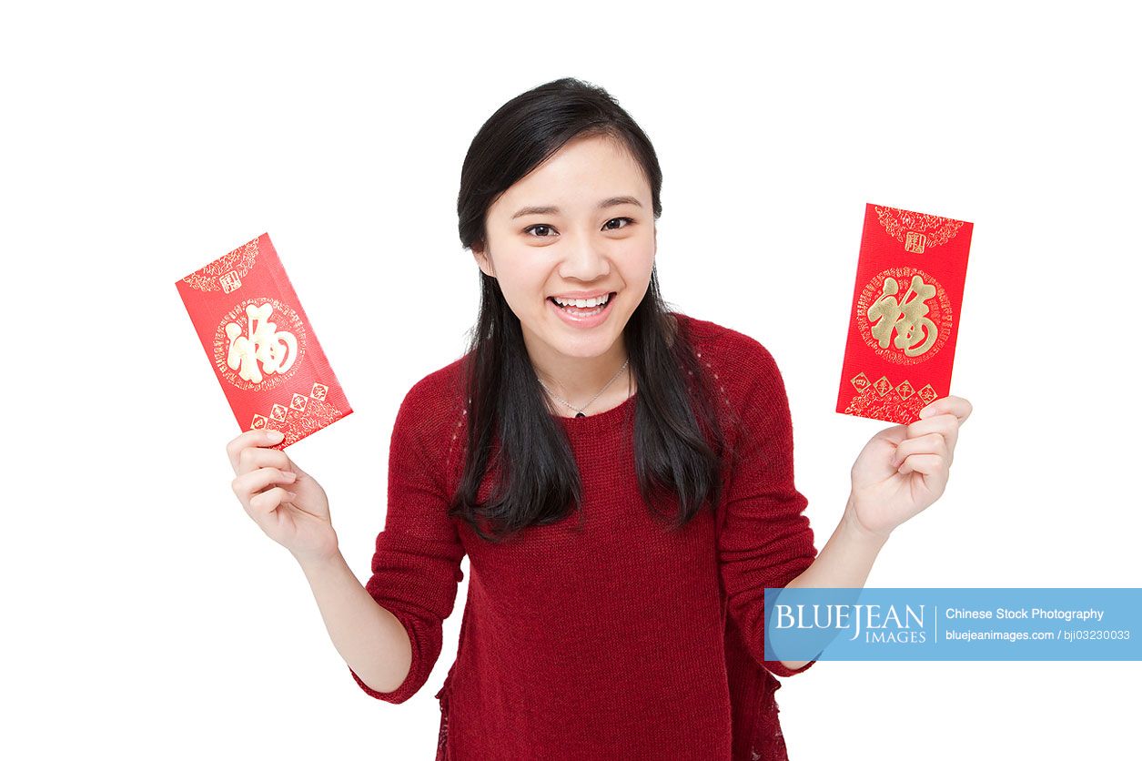 Joyful Young Chinese Woman Holding Traditional Red Pockets High res 