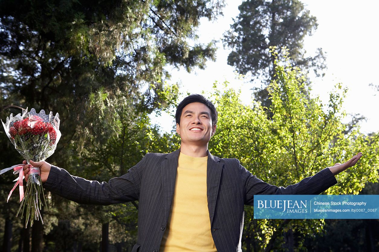 Chinese Young Man With Bunch Of Flowers
