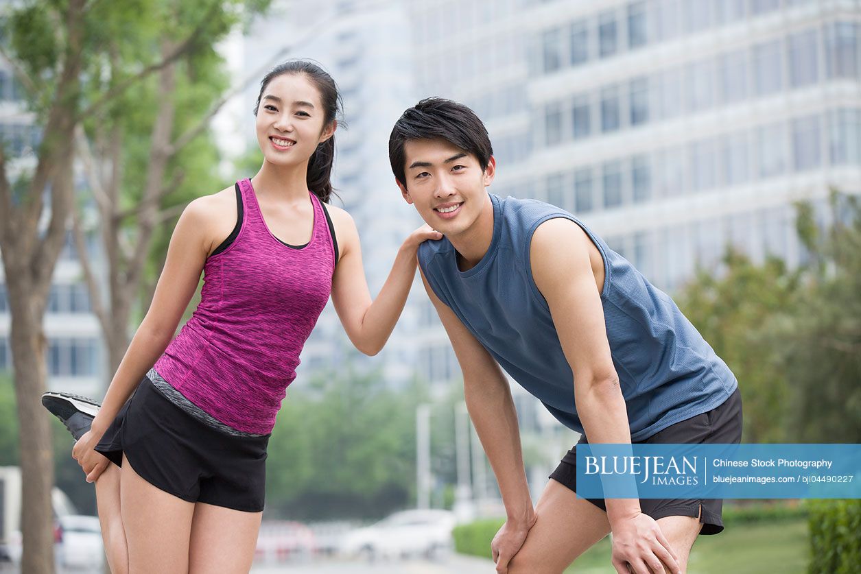 Young Chinese couple doing exercise outside