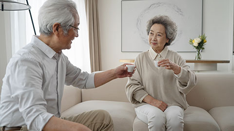 Cheerful senior Chinese couple drinking tea at home,4K