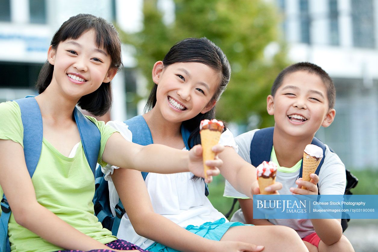 Happy Chinese schoolchildren and ice cream cones