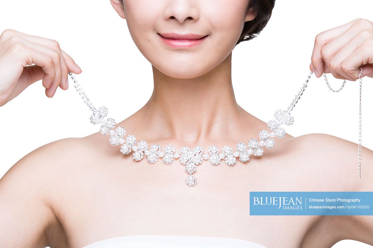 Beautiful young Chinese woman with diamond necklace