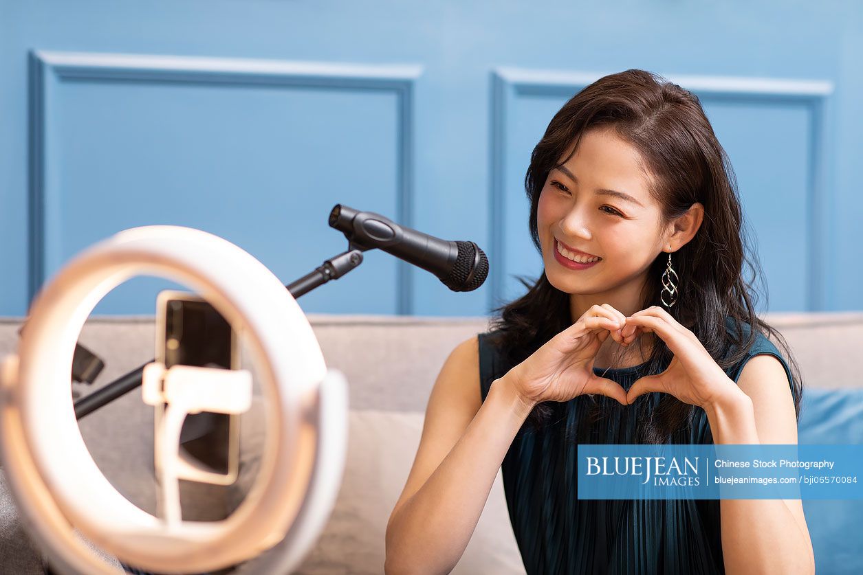 Young Chinese woman doing live webcast