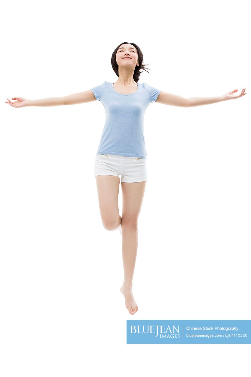 Young Chinese woman sleeping in mid-air