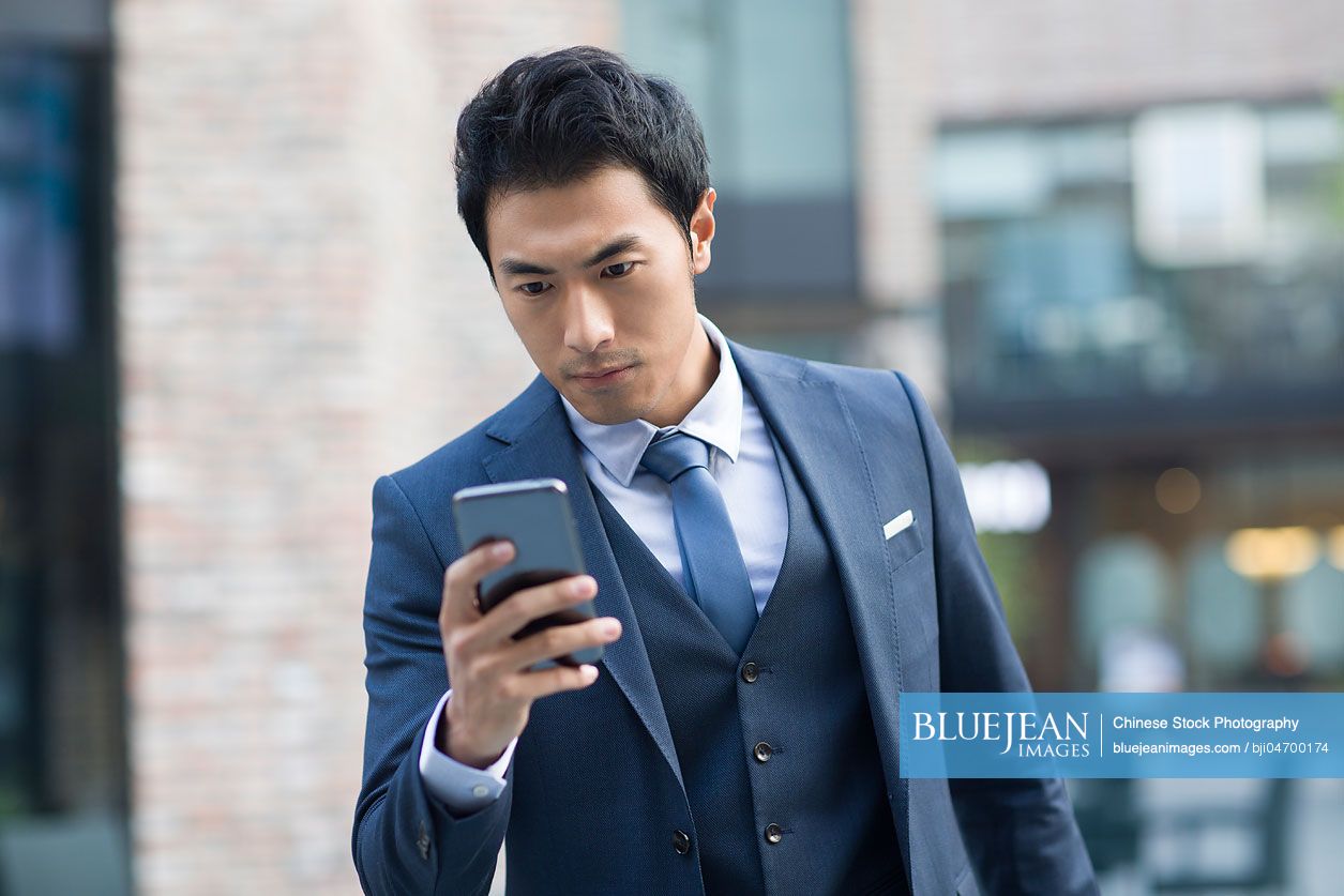 Confident Chinese businessman using smart phone-High-res stock photo ...