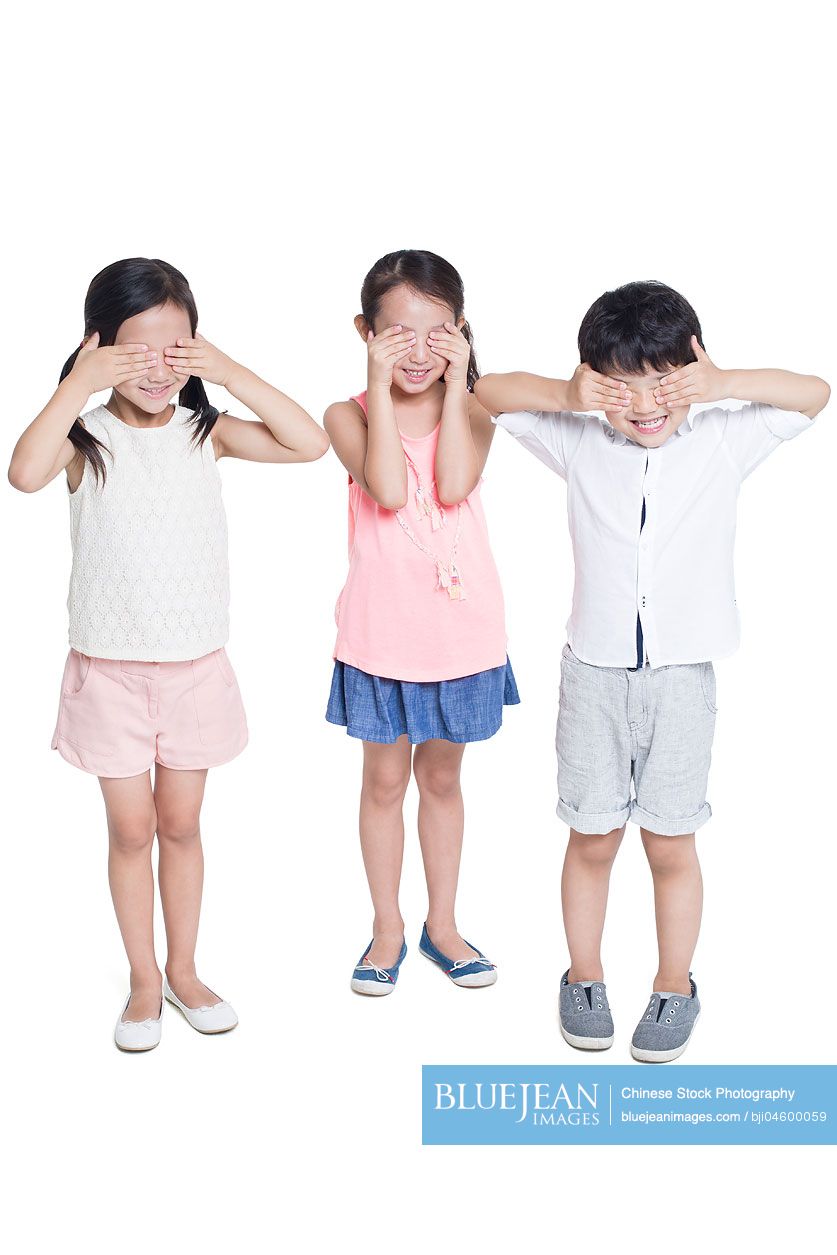 Happy Chinese children covering eyes with hands