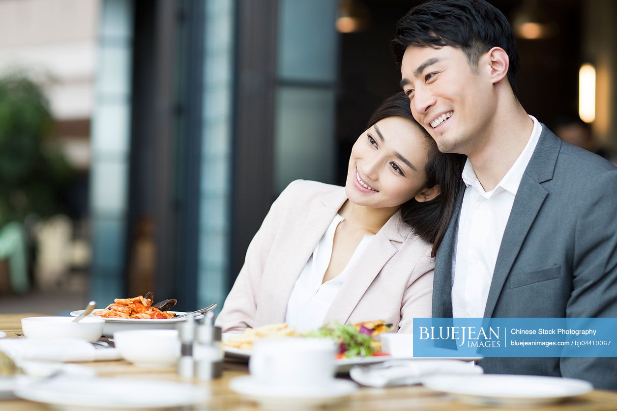Young Chinese couple dining in restaurant