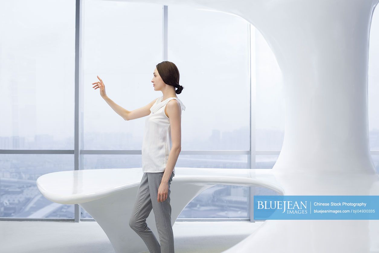 Businesswoman using advanced touch screen technology in office-High-res ...