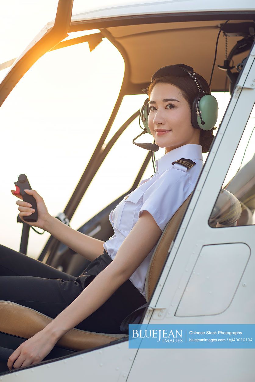 Chinese pilot sitting in helicopter cockpit