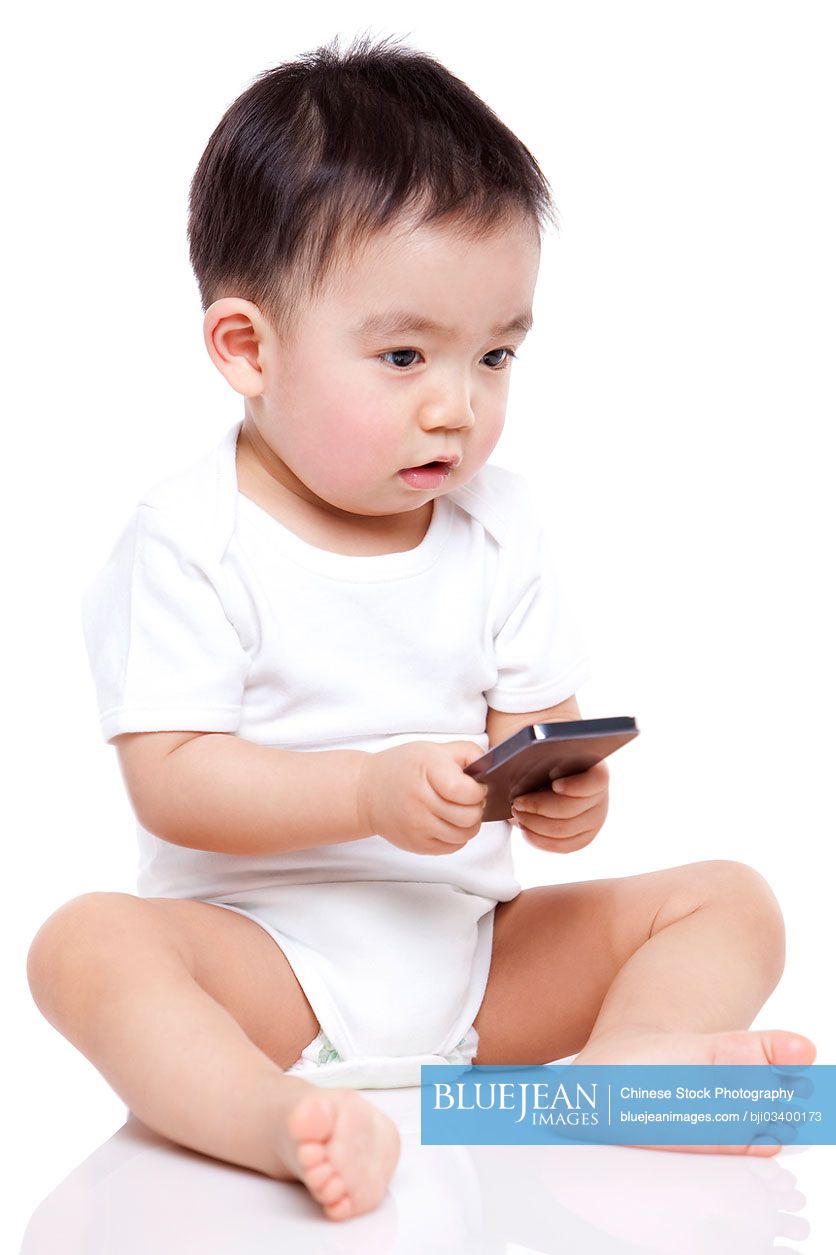 Adorable Chinese baby boy with smart phone