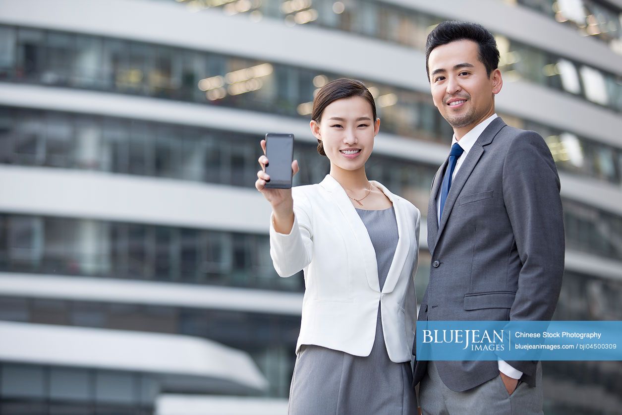 Chinese business person showing smart phone