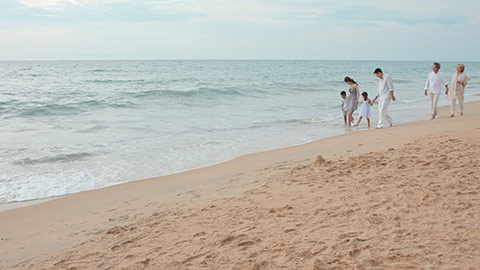 Happy Chinese family walking on beach,4K