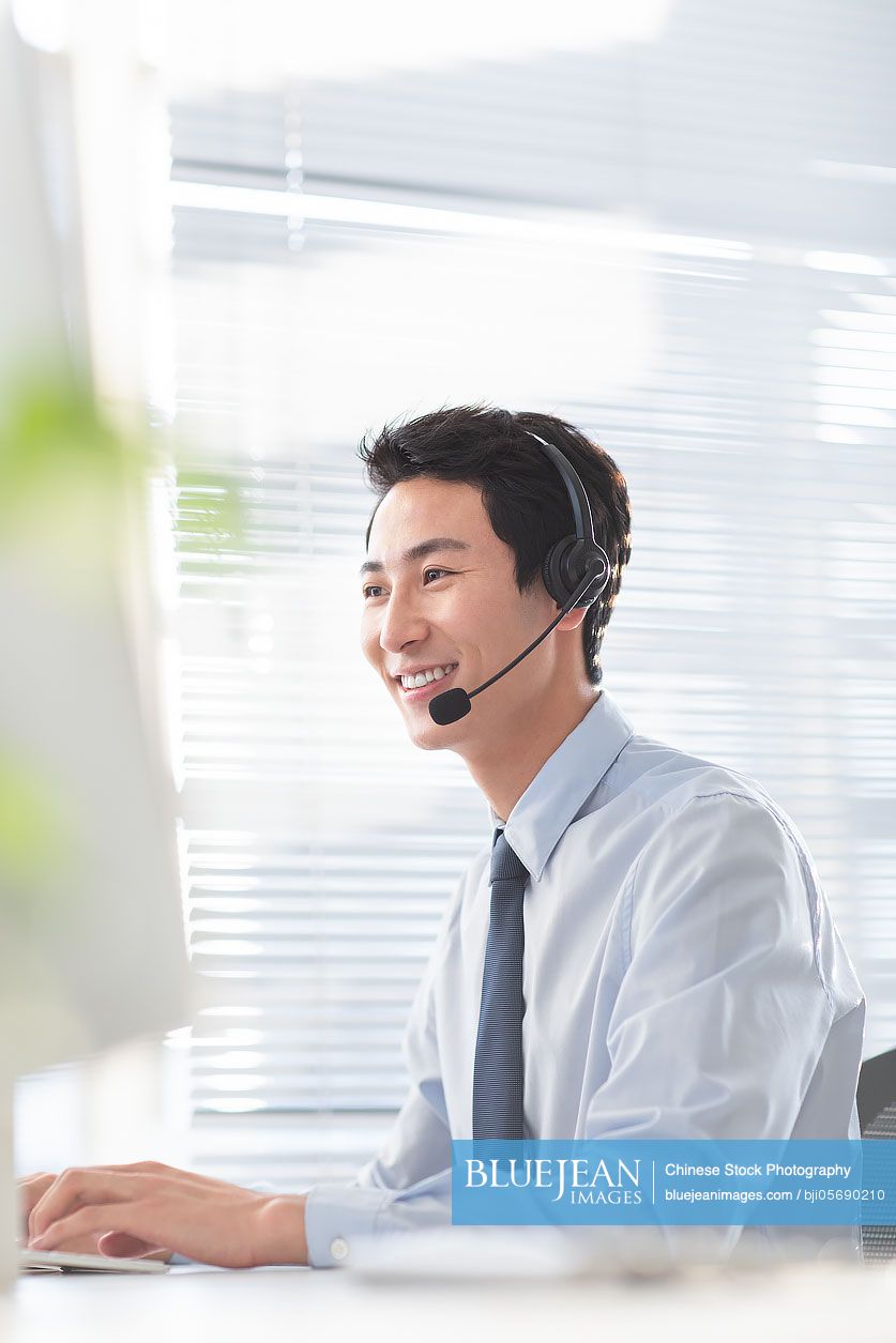 Young Chinese businessman working in office