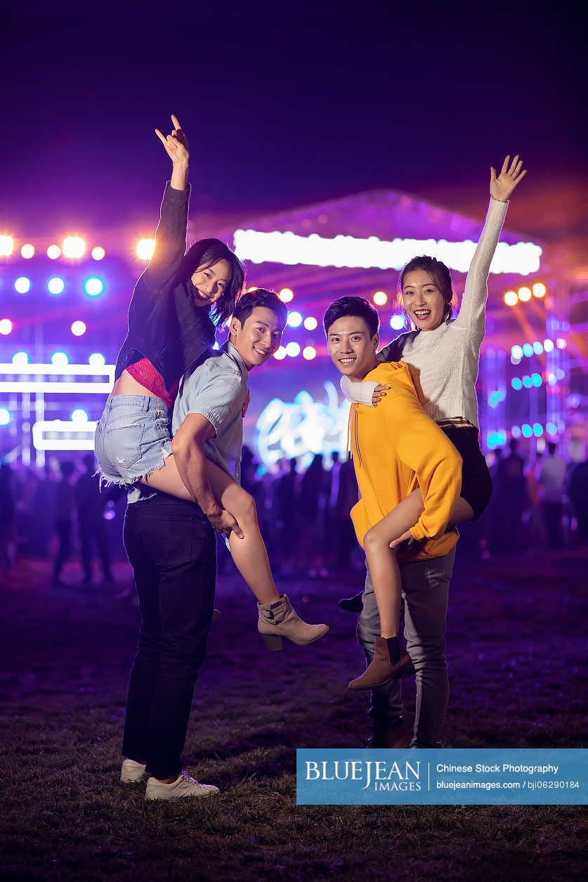 Happy young Chinese friends at music festival