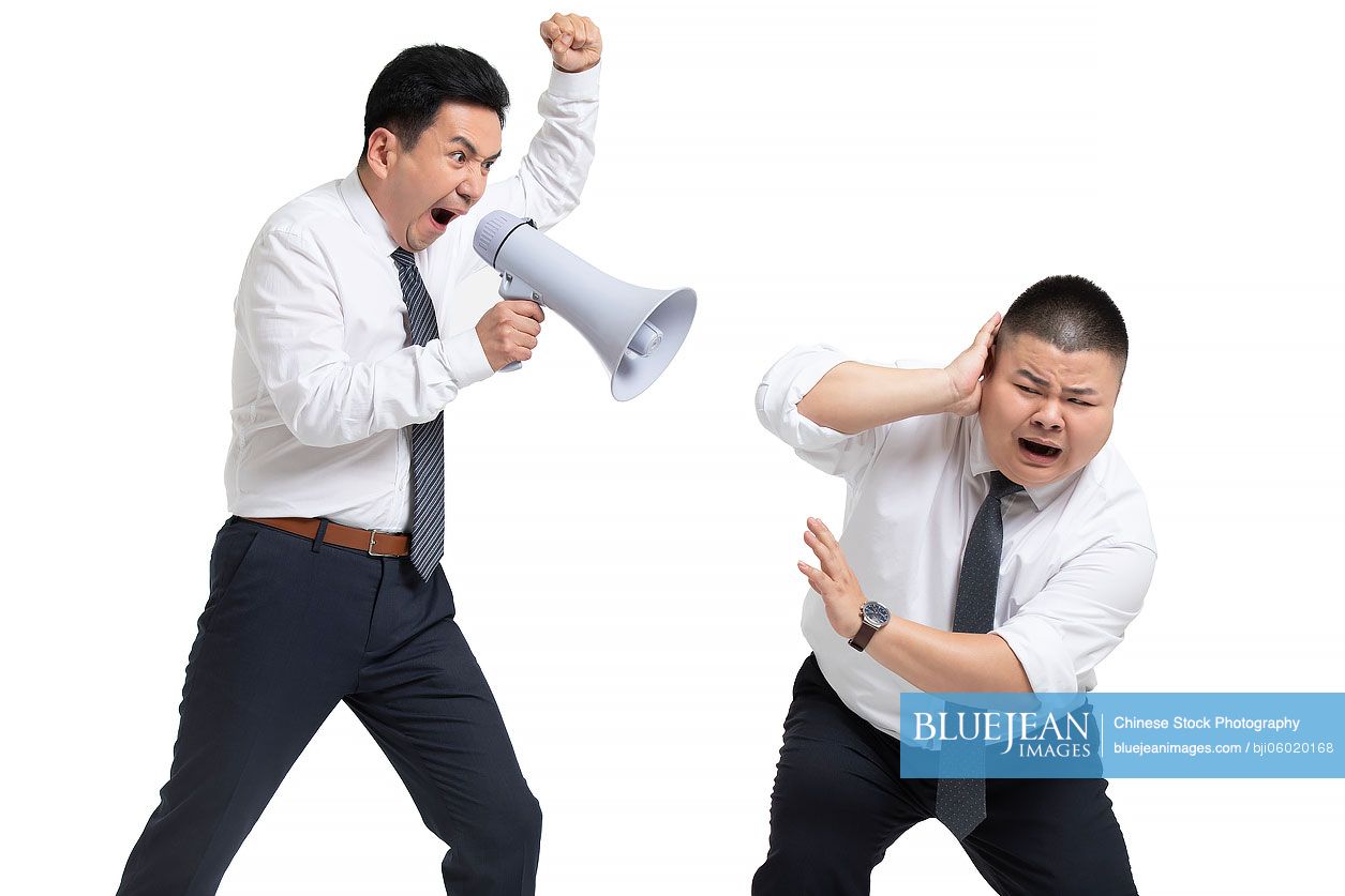 Mature Chinese businessman shouting at coworker