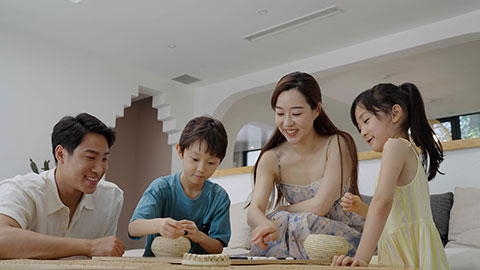 Family enjoying a game of Go in the hotel room