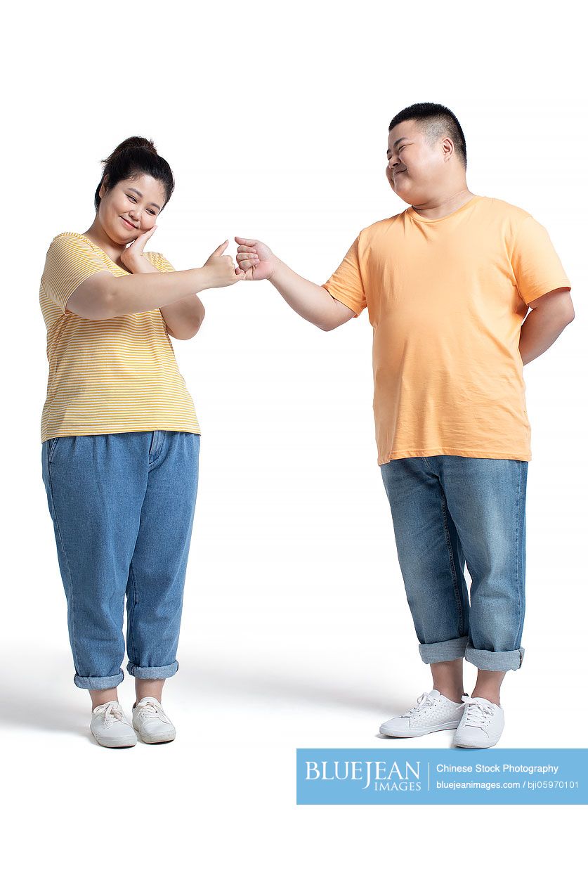 Happy young Chinese couple making pinky promise