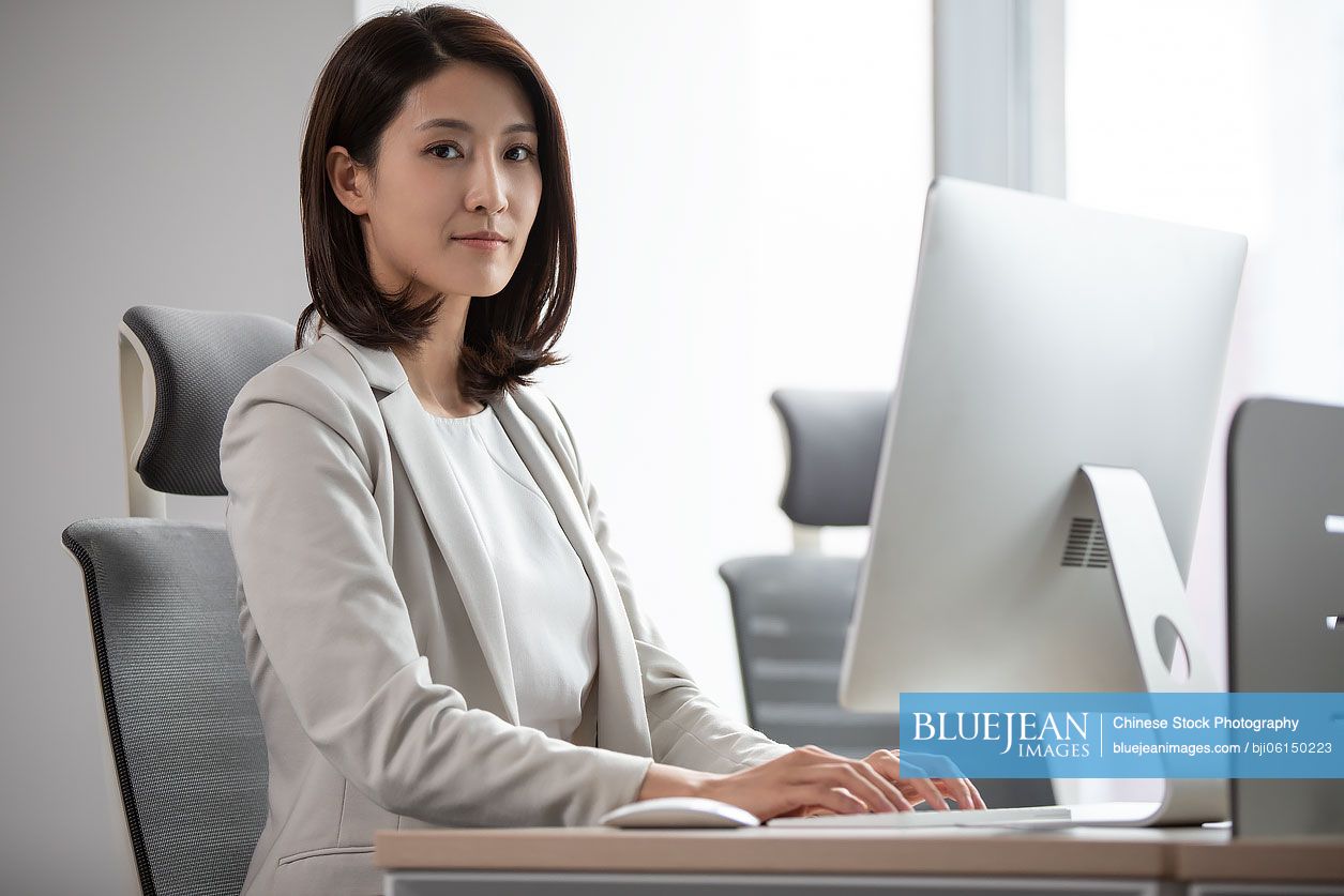 Young Chinese businesswoman working in office
