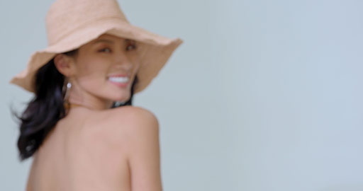 Young Chinese woman in bikini wearing sun hat,4K