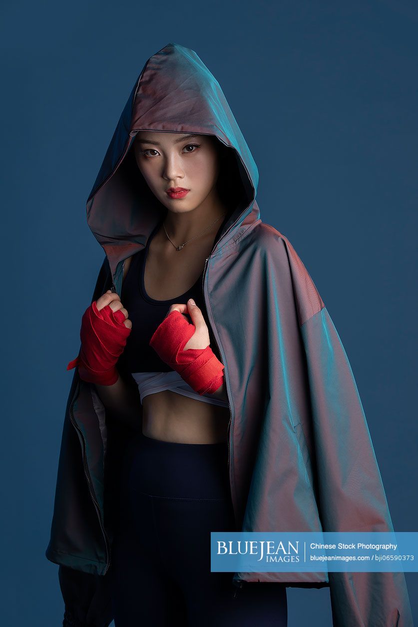 Confident young Chinese woman in hand wraps