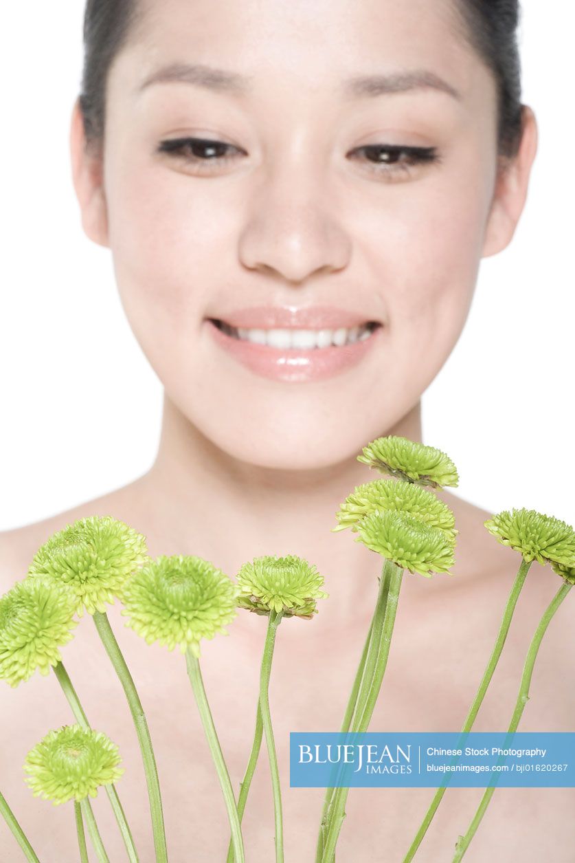Beauty shot of a young Chinese woman with Chrysanthemums