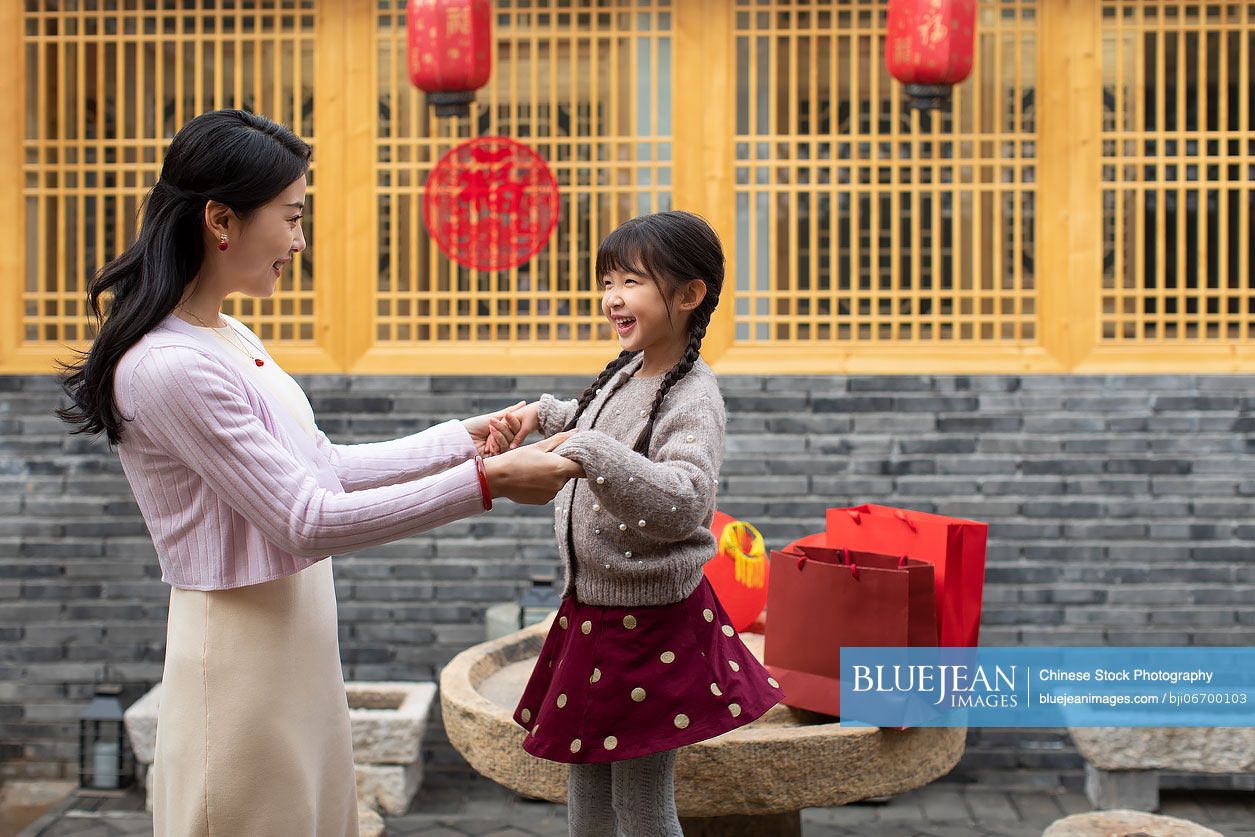 Happy mother and daughter celebrating Chinese New Year